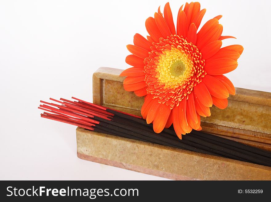 Incense sticks in their box and flower in white background. Incense sticks in their box and flower in white background