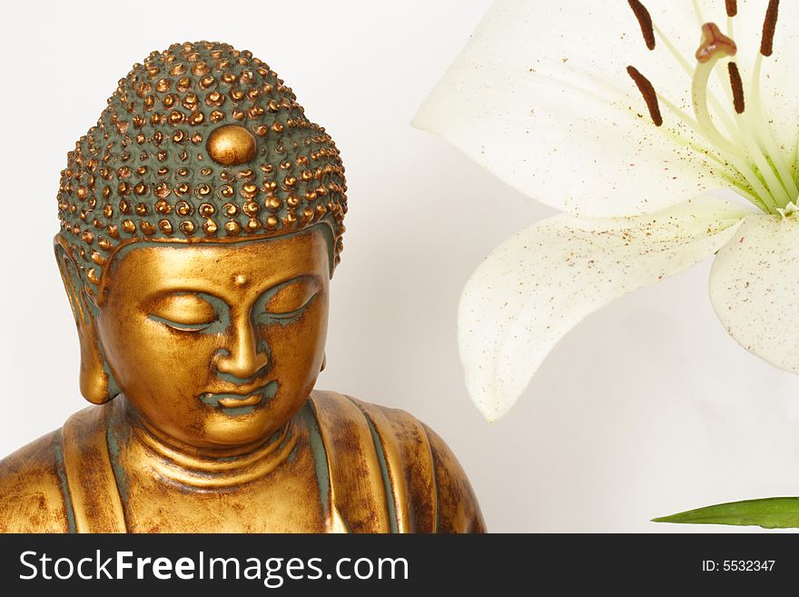 Serene bust of Buddha and Madonna lily. Serene bust of Buddha and Madonna lily