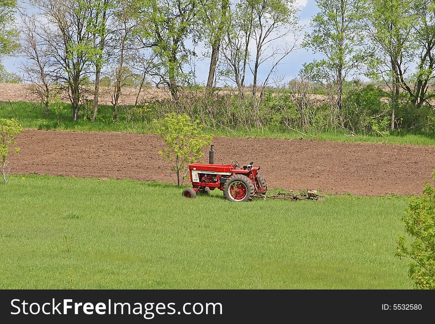 Tractor in the bright green pasture