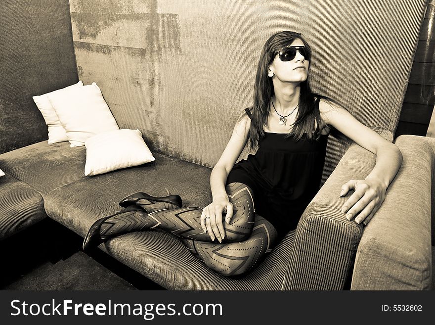 Young attractive female adult sitting on sofa