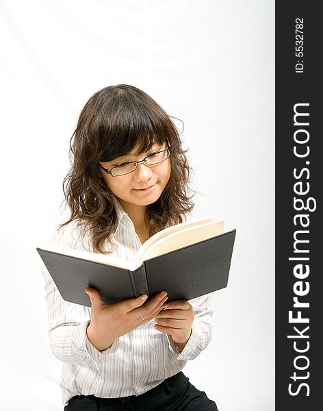 An asian female is reading a book. Portrait in white background, easy to cut out. An asian female is reading a book. Portrait in white background, easy to cut out.