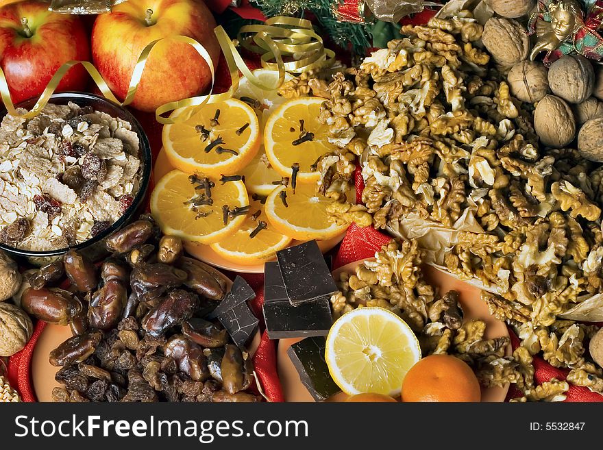 Christmas background - walnuts, oranges, apples, chocolates