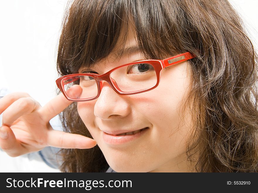 A very cute girl wearing red frame glass and light blue shirt is gesturing as a victor