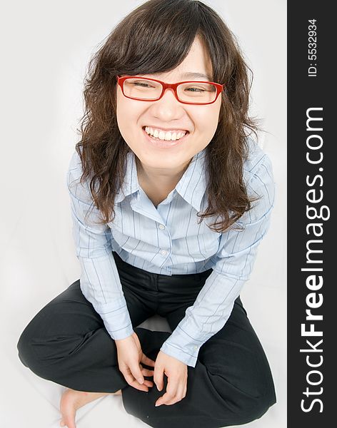A asian girl is laughing happily. bared feet on white background. A asian girl is laughing happily. bared feet on white background