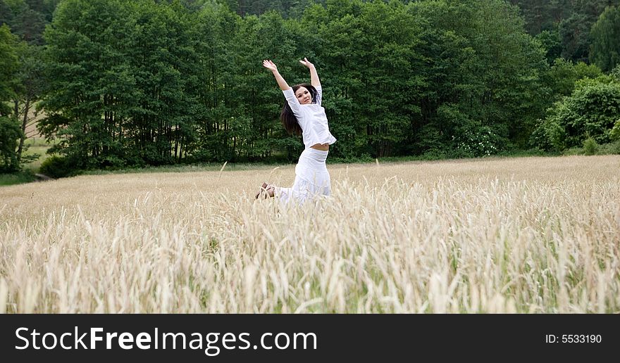 Attractive brunette woman on field. Attractive brunette woman on field