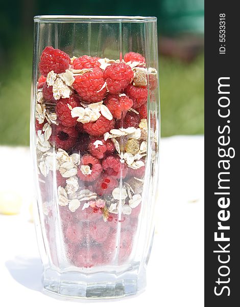 Raspberry with oat flakes in glass