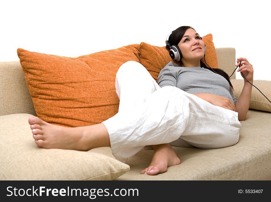 Attractive woman with headphones on sofa. Attractive woman with headphones on sofa