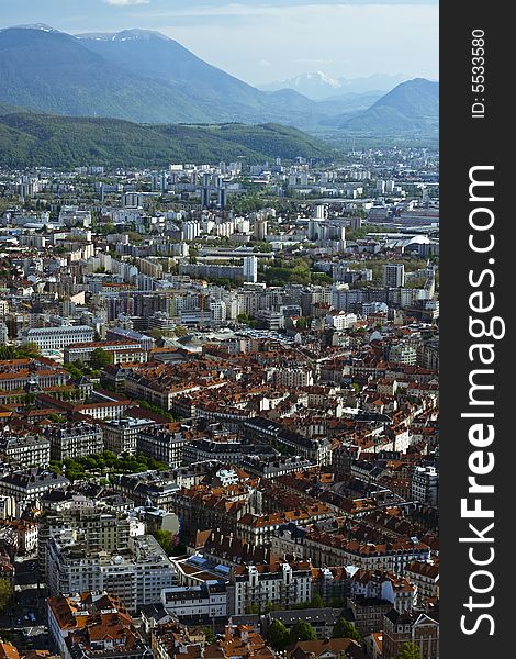 Wide angle view of Grenoble with Isere at the bottom and cloudy sky. Wide angle view of Grenoble with Isere at the bottom and cloudy sky.