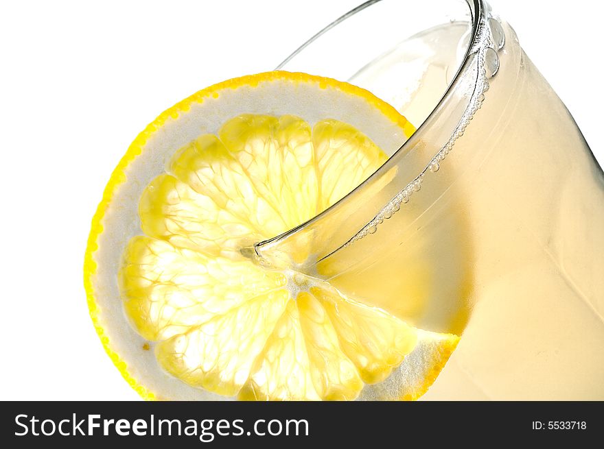 Glass of apple juice with lemon slice isolated on white