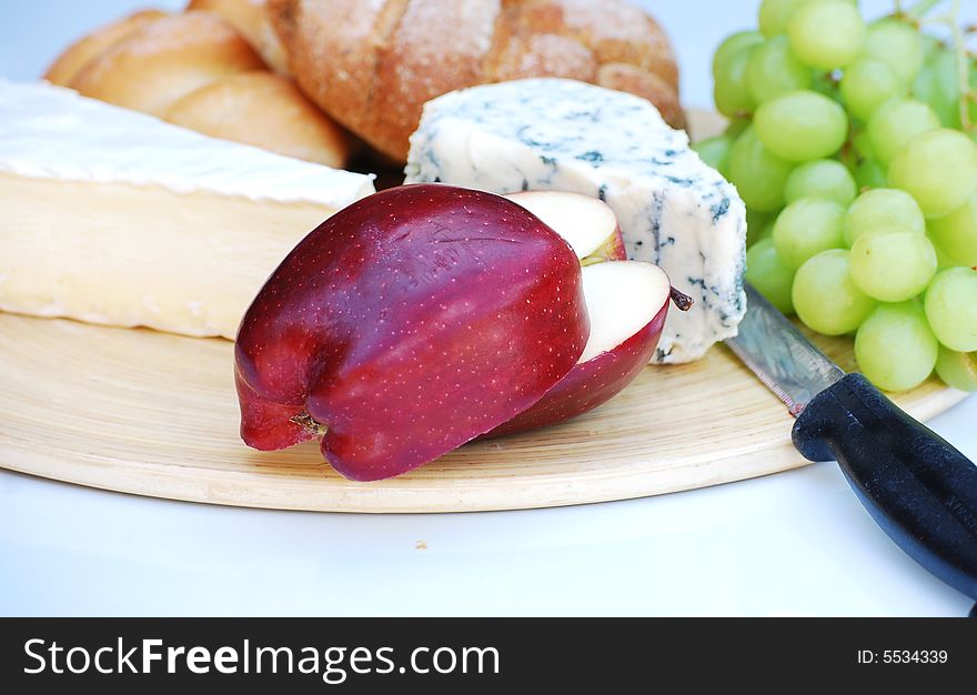 A shot of some bread,cheeses and fruit. A shot of some bread,cheeses and fruit