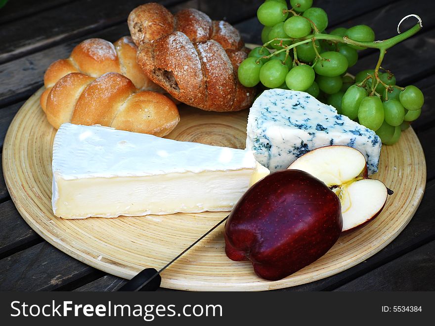 A shot of some bread,cheeses and fruit. A shot of some bread,cheeses and fruit