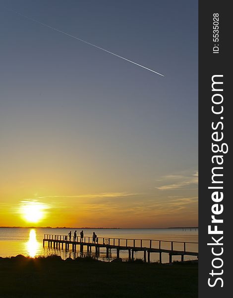 Airplane flying over the sea during the sunset. Airplane flying over the sea during the sunset.