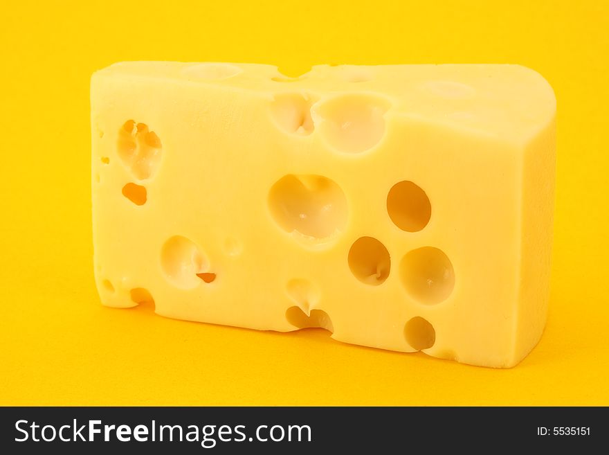 Cheese isolated on yellow background