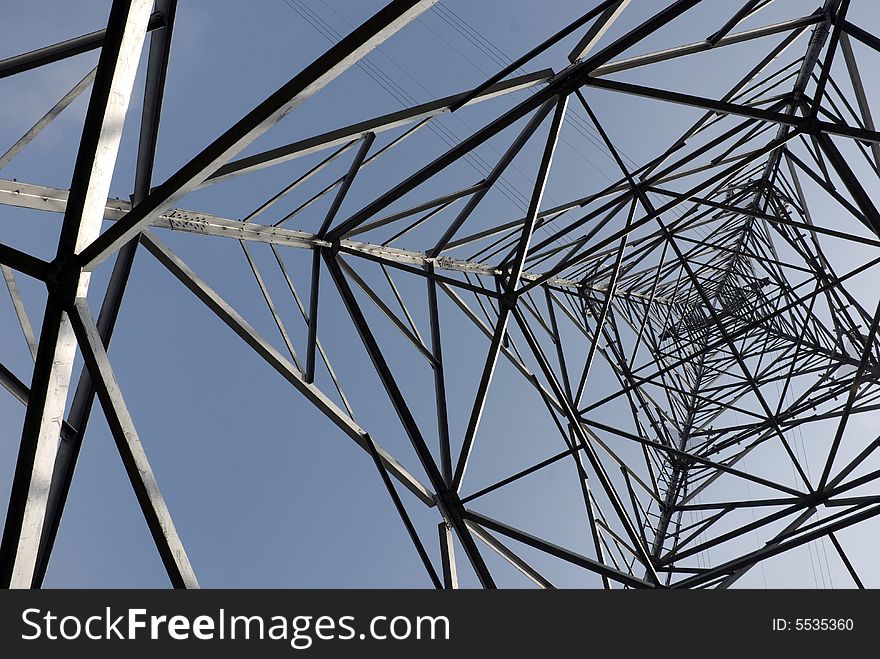 Impressive electric pylons transporting electricity through high tension cables. Impressive electric pylons transporting electricity through high tension cables.