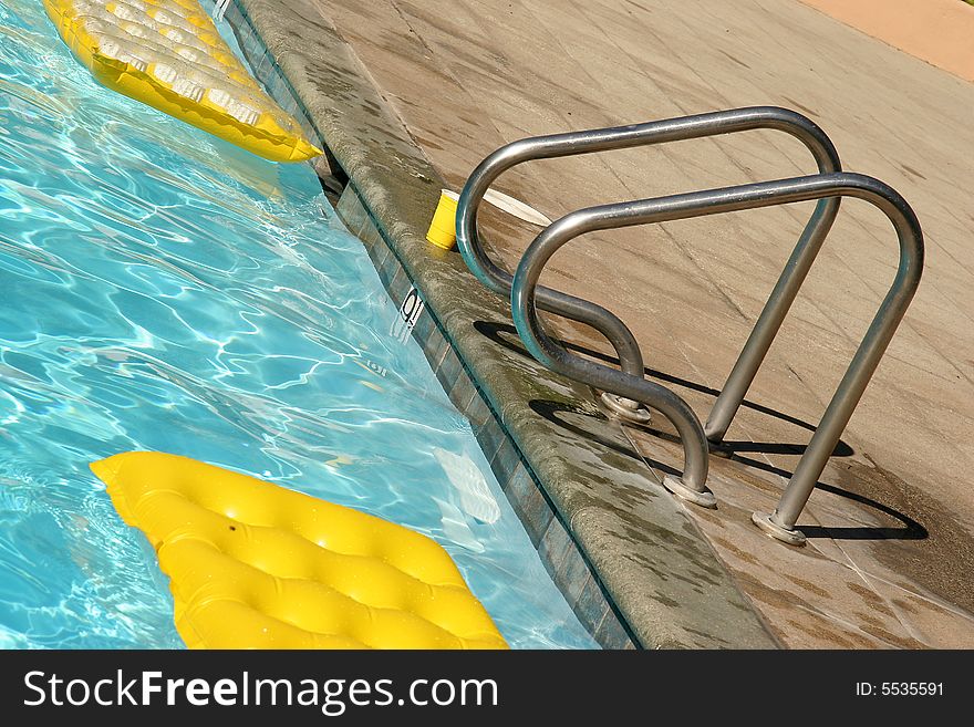 Bright yellow water mattress in the pool. Bright yellow water mattress in the pool