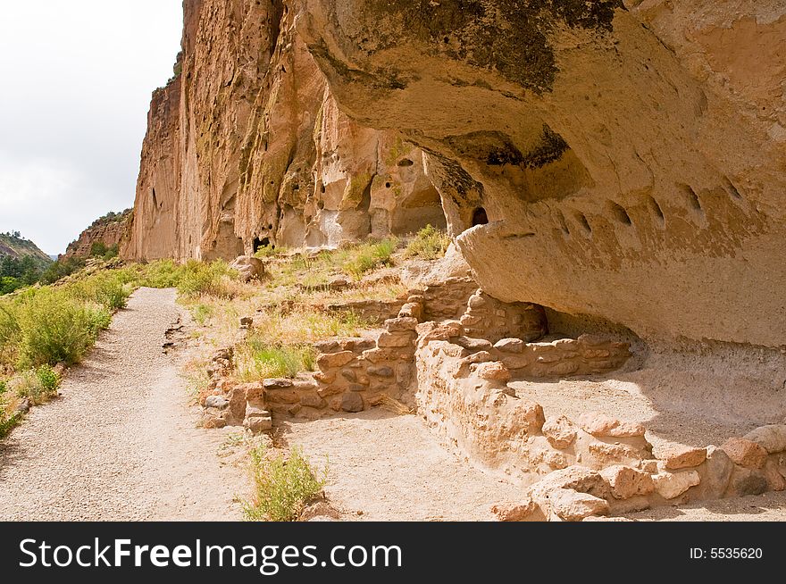 A view of the remains of a large native American Indian cliff dwelling in Bandelier National Monument, New Mexico. A view of the remains of a large native American Indian cliff dwelling in Bandelier National Monument, New Mexico.