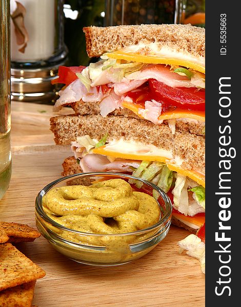 Whole wheat turkey sandwich with spicy mustard, crackers, tomato, cheese, lettuce. Whole wheat turkey sandwich with spicy mustard, crackers, tomato, cheese, lettuce.