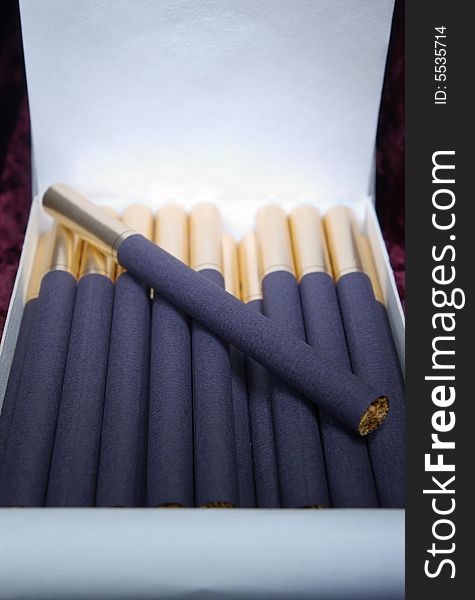 A pack of expensive cigarettes opened close-up. A pack of expensive cigarettes opened close-up