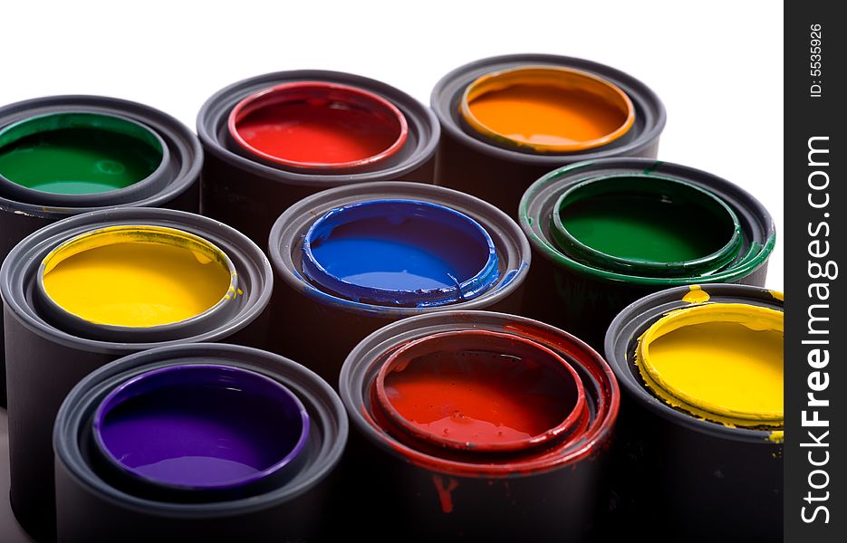 Cans of paint on a white background forming a colorful background. Cans of paint on a white background forming a colorful background