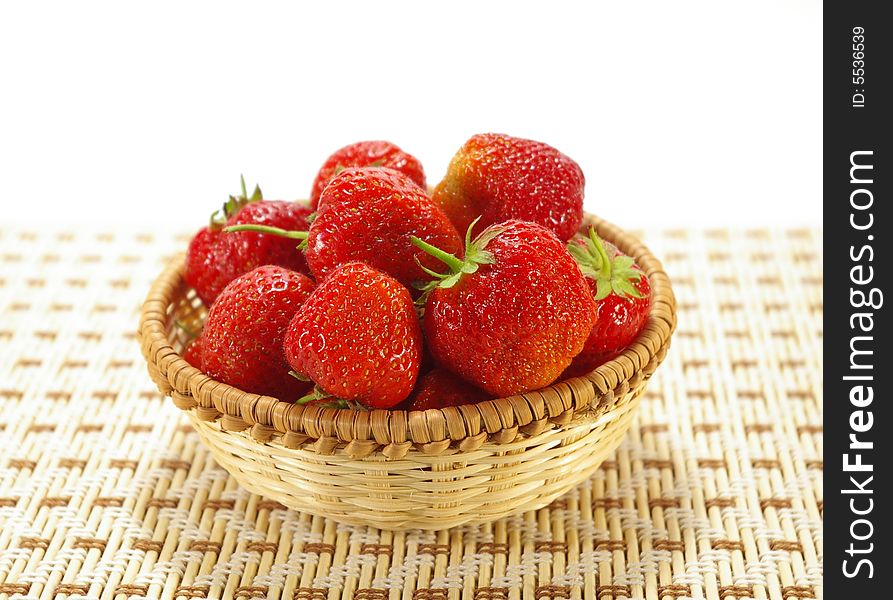 Ripe juicy strawberries in the braided basket. Ripe juicy strawberries in the braided basket