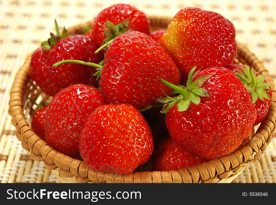 Ripe juicy strawberries in the braided basket