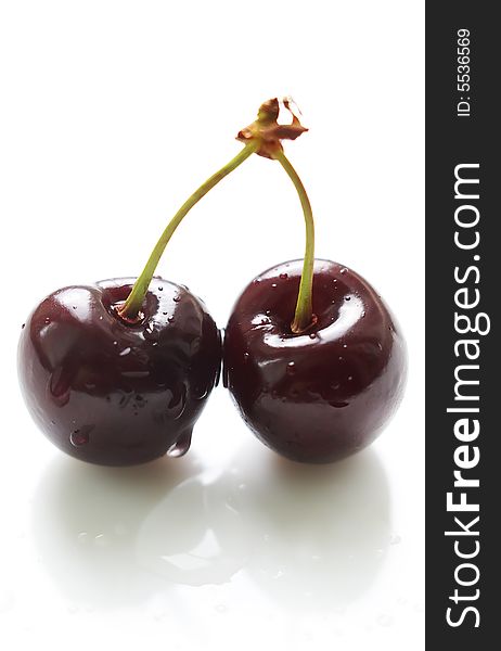 Two cherries with waterdrops isolated on white