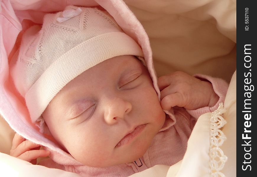 Portrait sleeping newborn baby girl in knitted bonnet, wrapped soft blanket. Portrait sleeping newborn baby girl in knitted bonnet, wrapped soft blanket