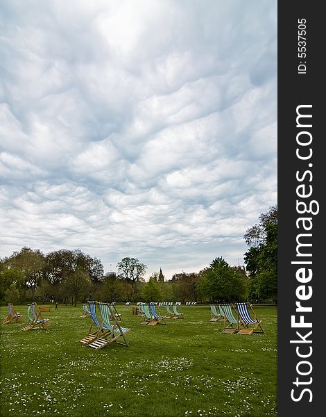 Empty deck chairs under dramatic cloudscape