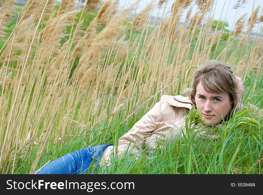 The girl lays in canes and looks in the cam. The girl lays in canes and looks in the cam