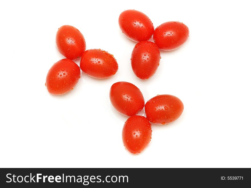 Few tomatoes arranged in flower pattern on white background. Few tomatoes arranged in flower pattern on white background