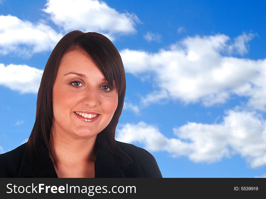 Smiling business woman over cloudy blue sky