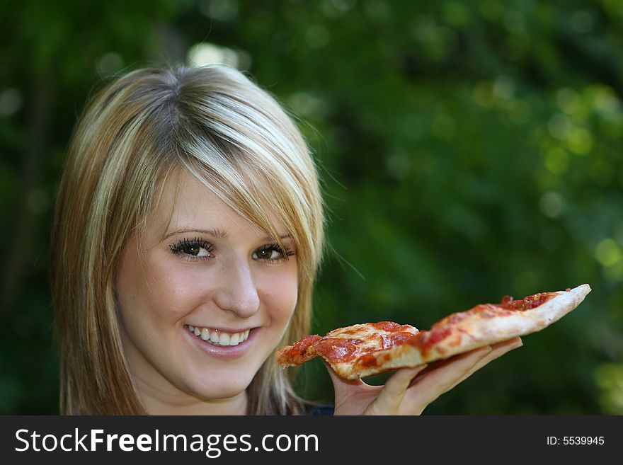 Girl eating pizza slice