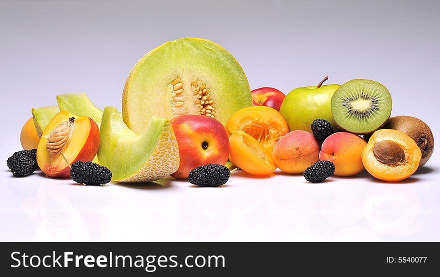 Variety of fresh colorful fruits on background