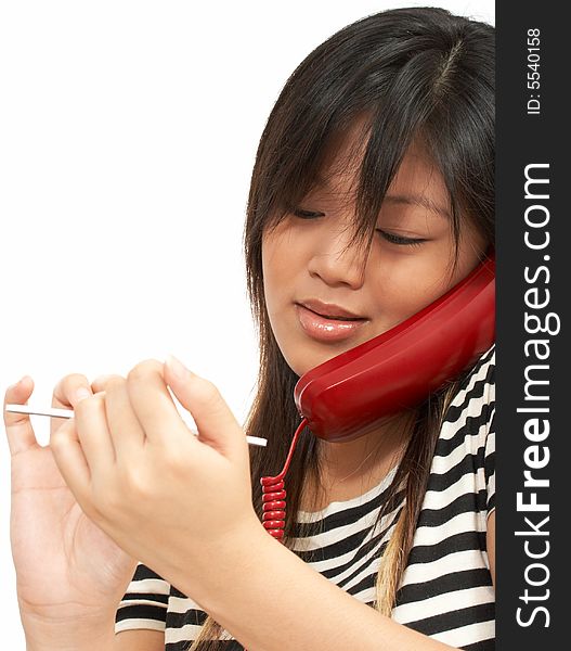 A  woman doing her nails while talking on the phone. A  woman doing her nails while talking on the phone