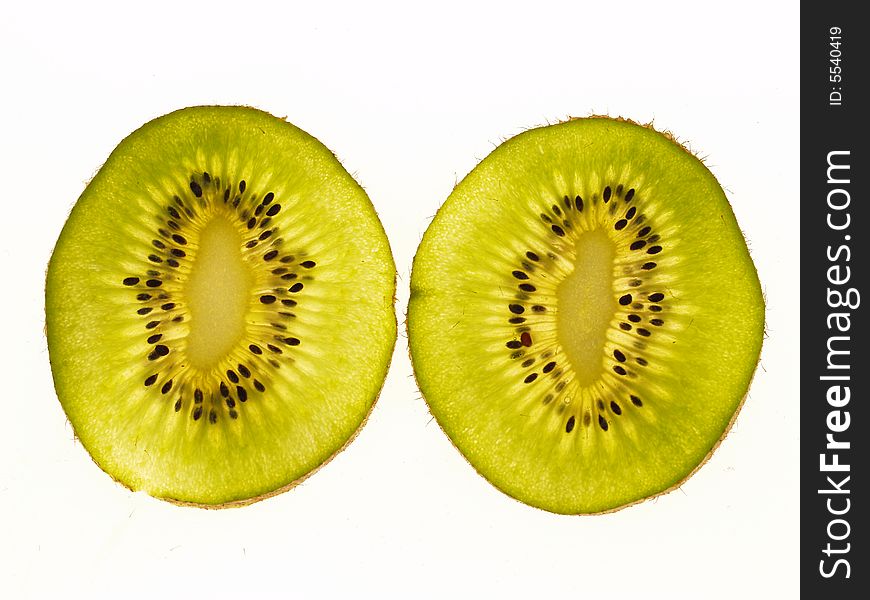 Two thin slices of kiwi fruit placed on a lightbox and photographed using a dedicated macro lens. Two thin slices of kiwi fruit placed on a lightbox and photographed using a dedicated macro lens