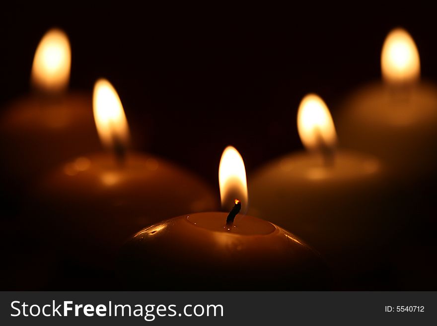 Burning candles arranged with symmetry. close up.