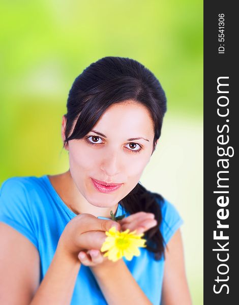 Young woman holding yellow flower. Young woman holding yellow flower