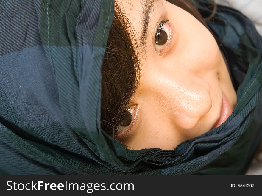 A young asian girl with a blue scarves. A young asian girl with a blue scarves