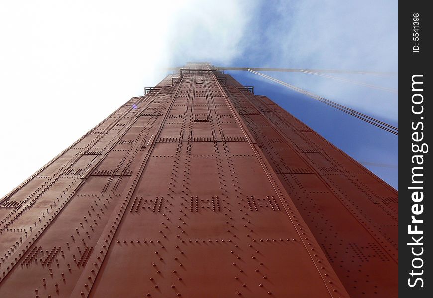 A detail of the Golden Gate bridge wrapped by the fog