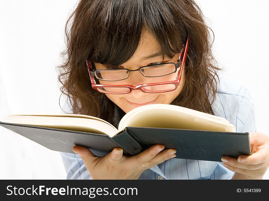 A cute office lady with two different color glass is reading a book with black cover. A cute office lady with two different color glass is reading a book with black cover.