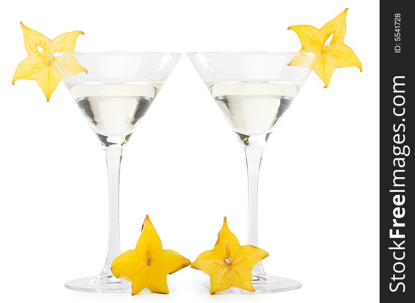 Glass of martini and slice of carambola on a white background. Glass of martini and slice of carambola on a white background