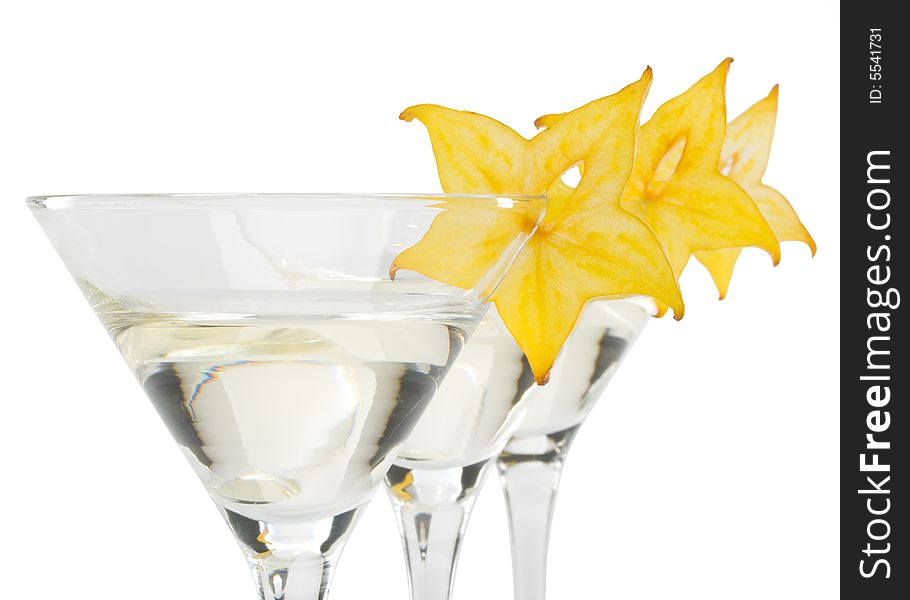 Glass of martini and slice of carambola on a white background. Glass of martini and slice of carambola on a white background