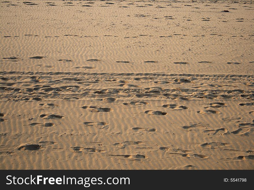 Footprints on the sand with waves