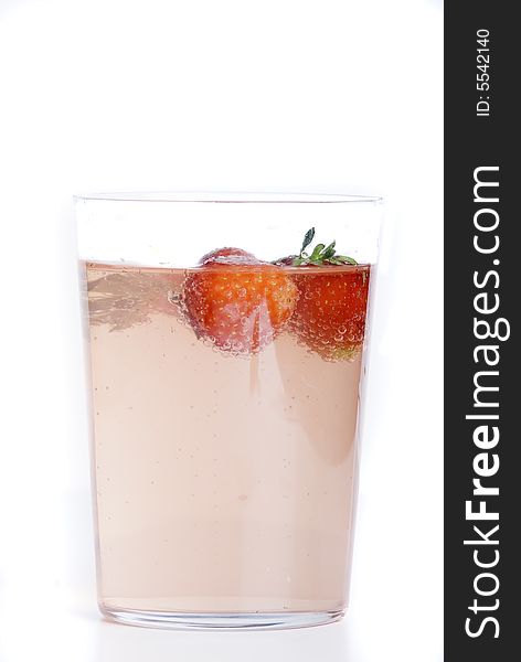 Fresh srawberry juice in a glass with strawberries on a white background. Fresh srawberry juice in a glass with strawberries on a white background