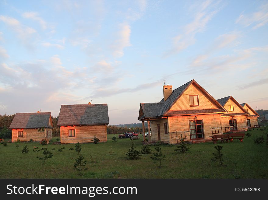 Group of small houses in red sunshine light.