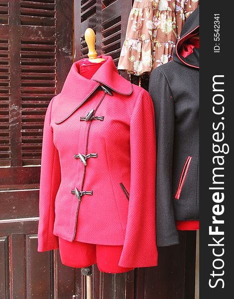 Tailored pink jacket on display at a shop in Hoi An, Vietnam - travel and tourism.