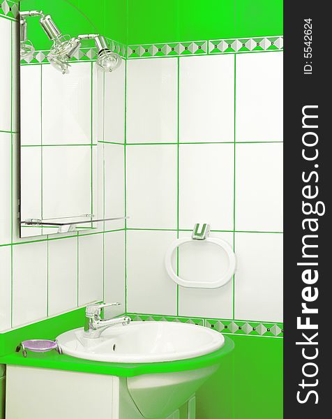 Green bathroom detail with mirror