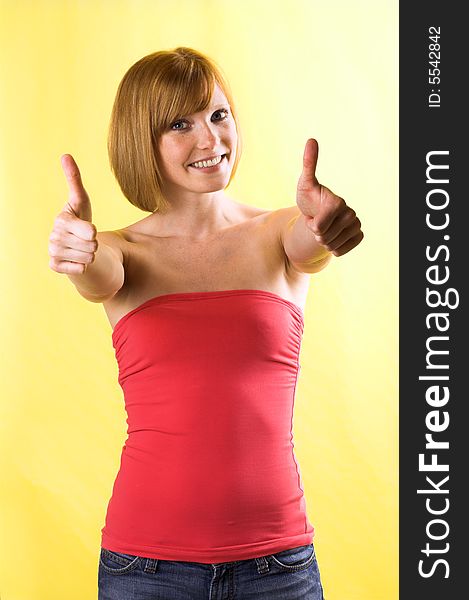 Portrait of a young, attractive and happy woman is smiling with thumb up. Portrait of a young, attractive and happy woman is smiling with thumb up