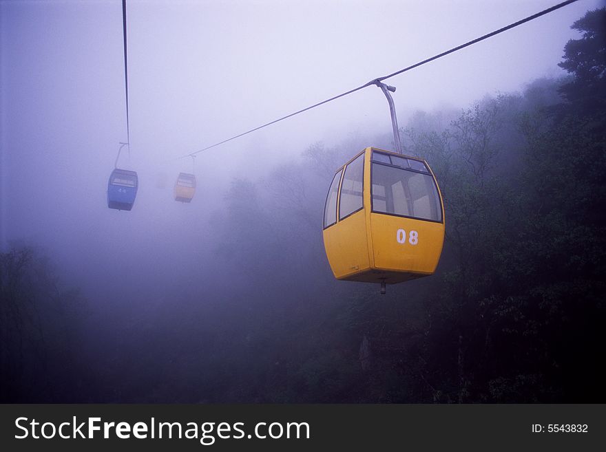 Cable cars coming out from heavy fog, taibaishan mountain, shanxi, china