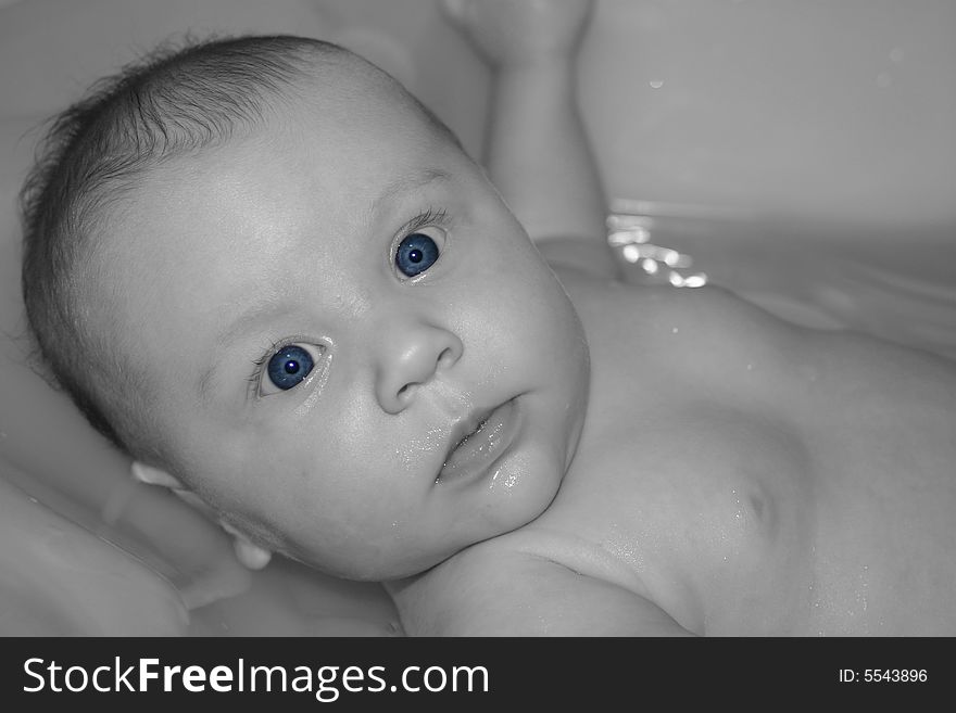Cute, chubby baby in the bath.  A very peculiar look on her face. Cute, chubby baby in the bath.  A very peculiar look on her face.